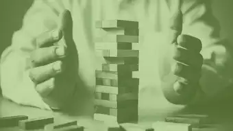 Man balancing Jenga bricks to represent stability